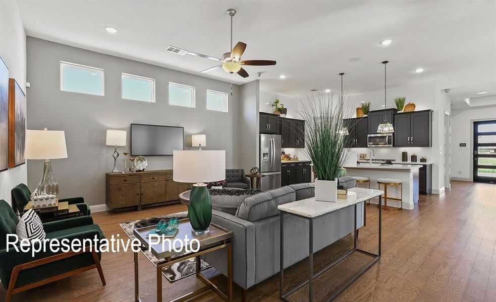 Living room featuring dark hardwood / wood-style flooring and ceiling fan