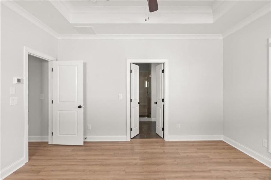 The tray ceiling adds character and provides the primary bedroom with a feeling of spaciousness. NOT actual home. Photos of previously built Grayton floorplan.