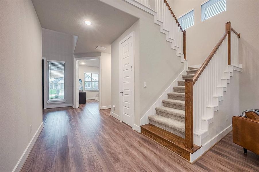 The stylish stairway leads to three bedrooms, two full bathrooms, and game room. Behind the door is a Texas-sized closet, perfect for storage.