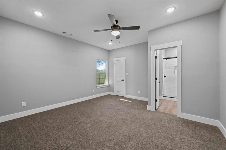 Unfurnished bedroom with carpet and ceiling fan