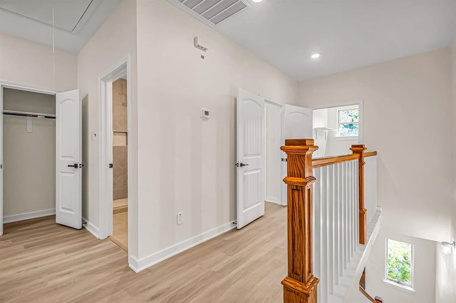 Second floor landing with access to the laundry room and bedrooms.