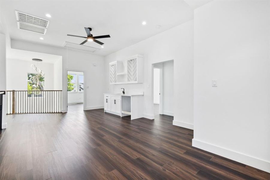 Unfurnished living room with dark wood-type flooring