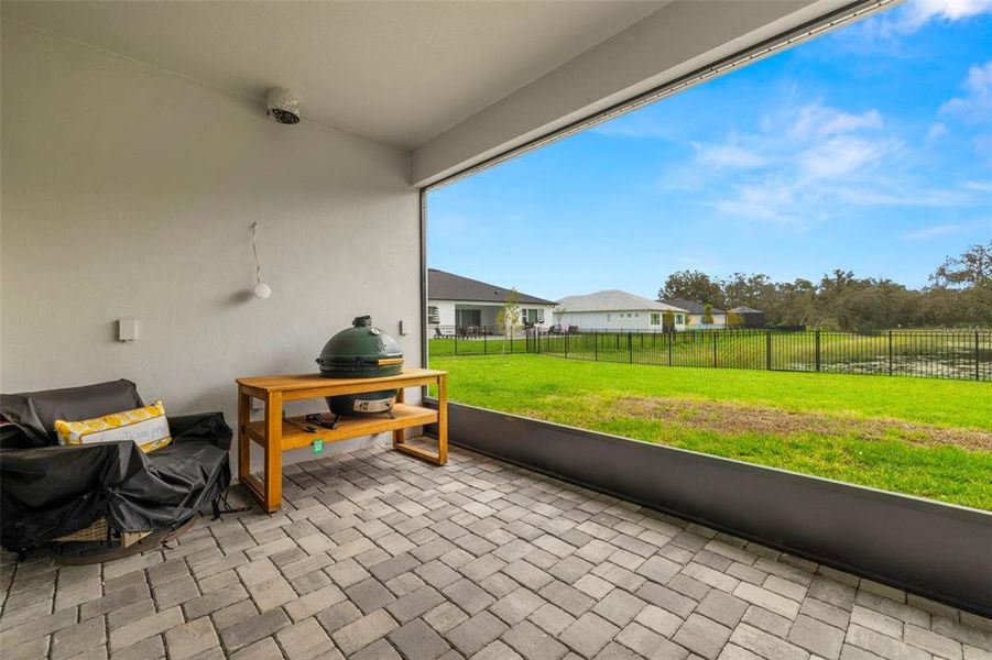 Enjoy drinking Your Coffee or Cocktails at the Covered/Screened Lanai with Pavers & Ceiling Fan Overlooking the Relaxing Pond Views