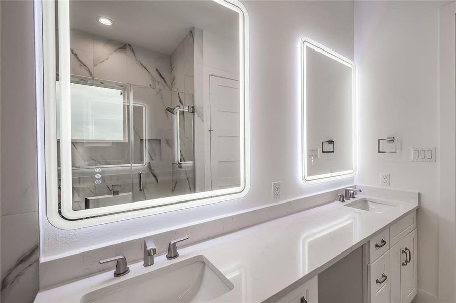 In the primary bath enjoy a double vanity with back lit and color changing mirrors to fit any mood.