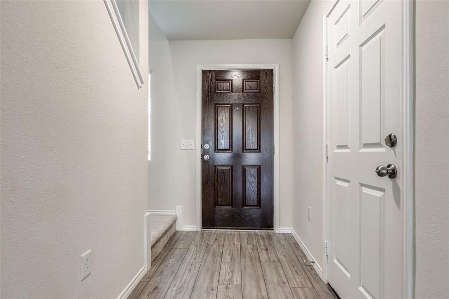 Entryway with light hardwood / wood-style floors