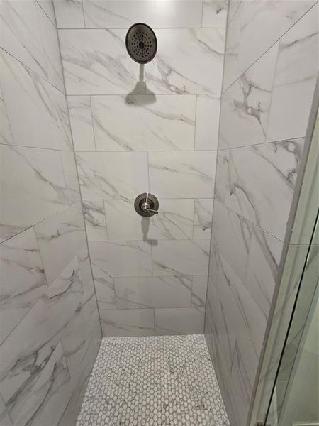 Bathroom featuring tiled shower