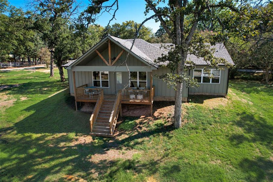 Rear view of house with a lawn