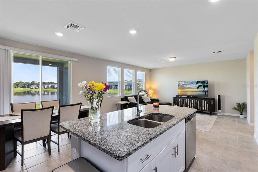 Kitchen overlooking the eat in area and family room with beautiful views of the water!