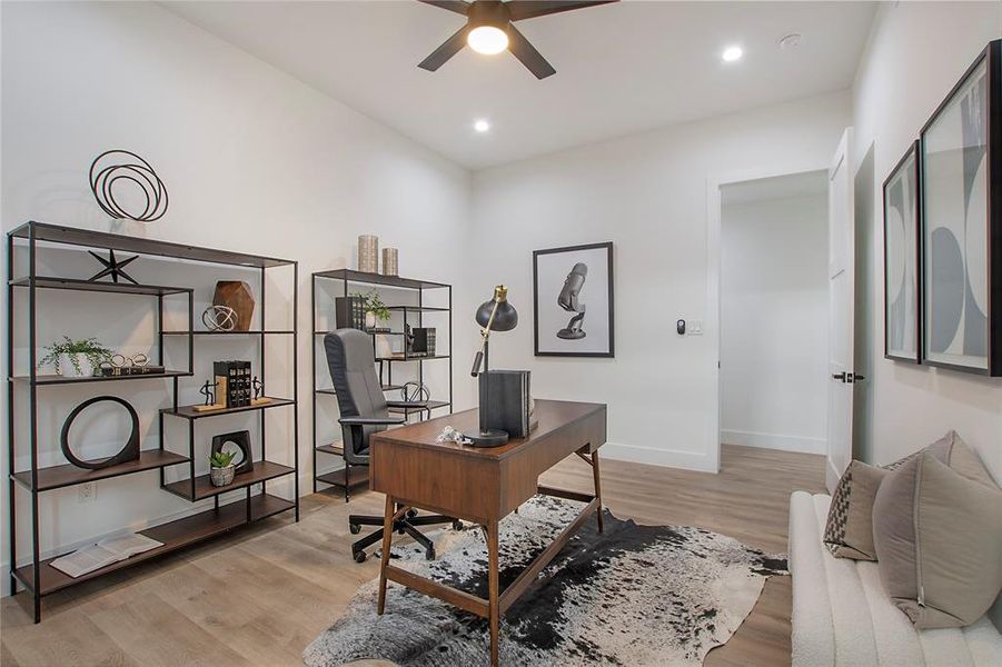 Office space with ceiling fan and light hardwood / wood-style floors