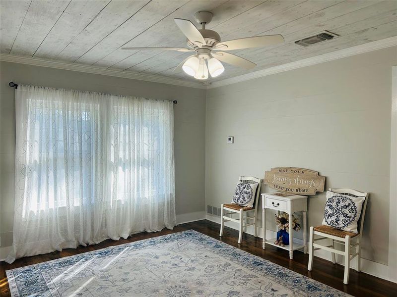 Living room with wooden ceiling, plenty of natural light, and dark hardwood / wood-style floors