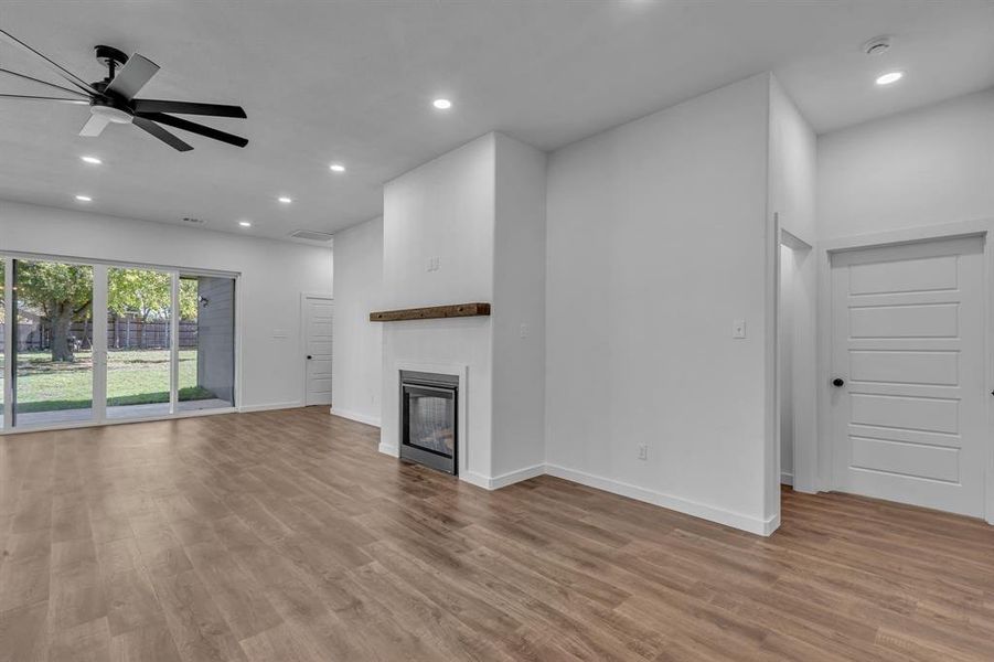 Unfurnished living room with light hardwood / wood-style floors and ceiling fan