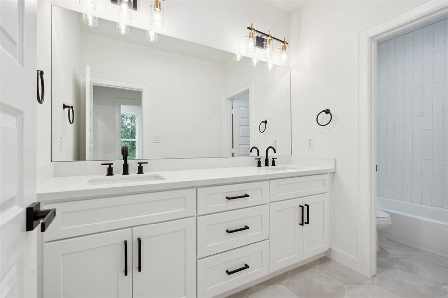 Convenience meets comfort in the secondary bathroom upstairs, designed with your guests in mind. Featuring dual sinks, this well-appointed space ensures that everyone has ample room, making it ideal for accommodating family and friends with ease.