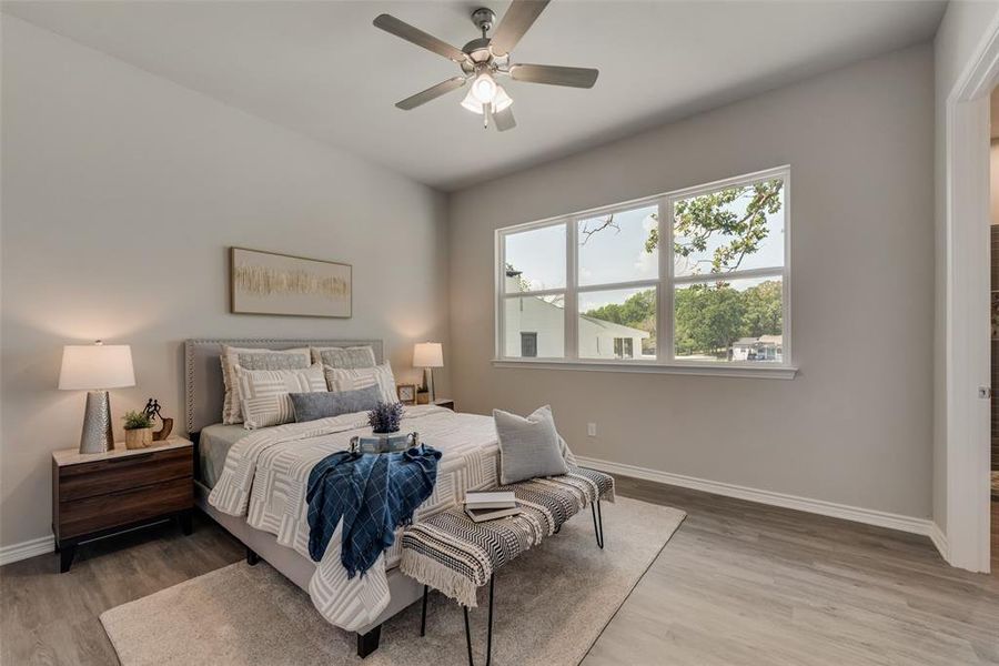 Bedroom with hardwood / wood-style flooring and ceiling fan