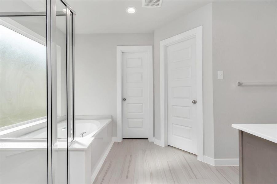 Step into a sanctuary of relaxation in your primary bathroom. Sample photo of completed home with similar floor plan. As-built interior colors and selections may vary.