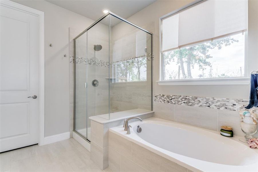 Bathroom with tile floors and independent shower and bath