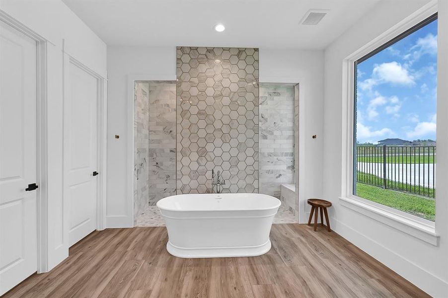 Featuring octagonal tiling that spans the full height of the walls, this bathroom boasts a spacious walk-in shower, creating a luxurious spa-like retreat.