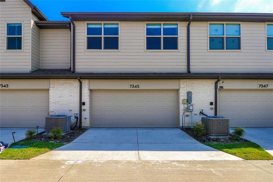 Rear of townhome with 2 car garage