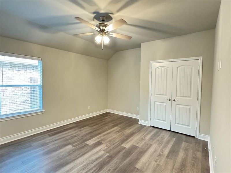 Unfurnished bedroom featuring a closet, wood-type flooring, and ceiling fan