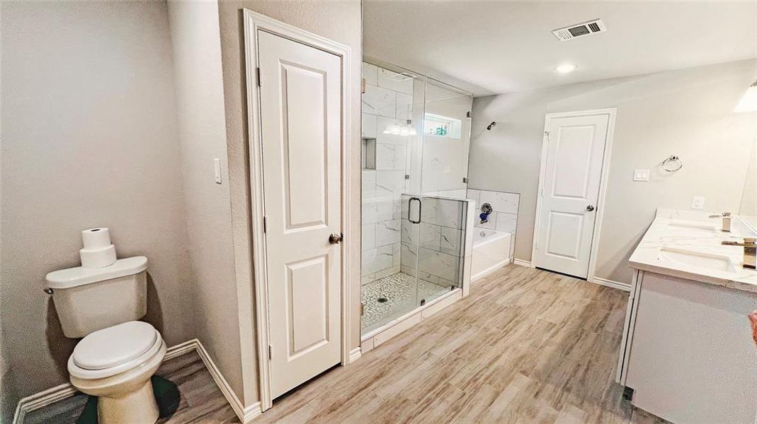 Primary bath features 2 showers and a bathtub