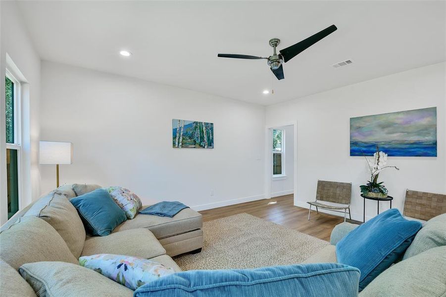 Living room featuring wood-style flooring and ceiling fan