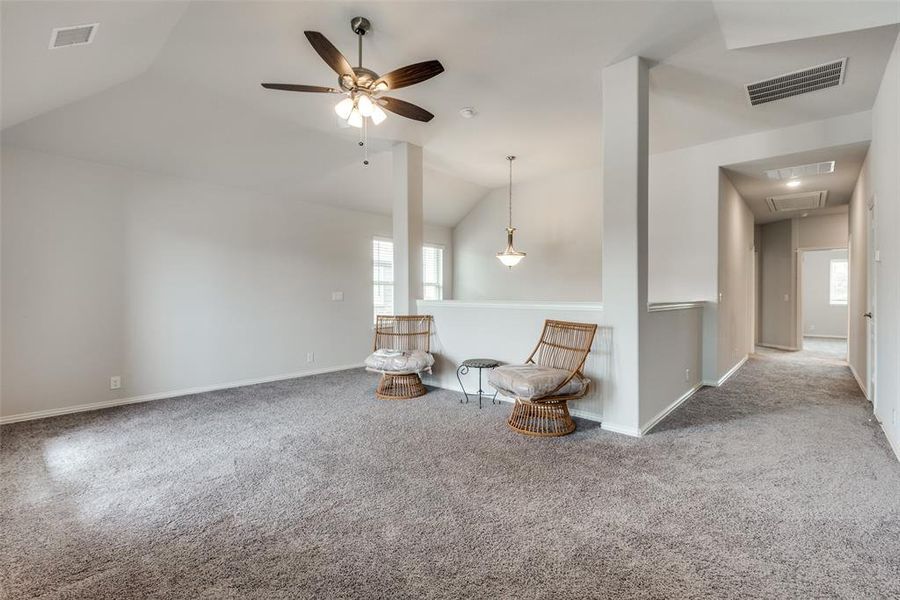 Unfurnished room featuring carpet, vaulted ceiling, and ceiling fan