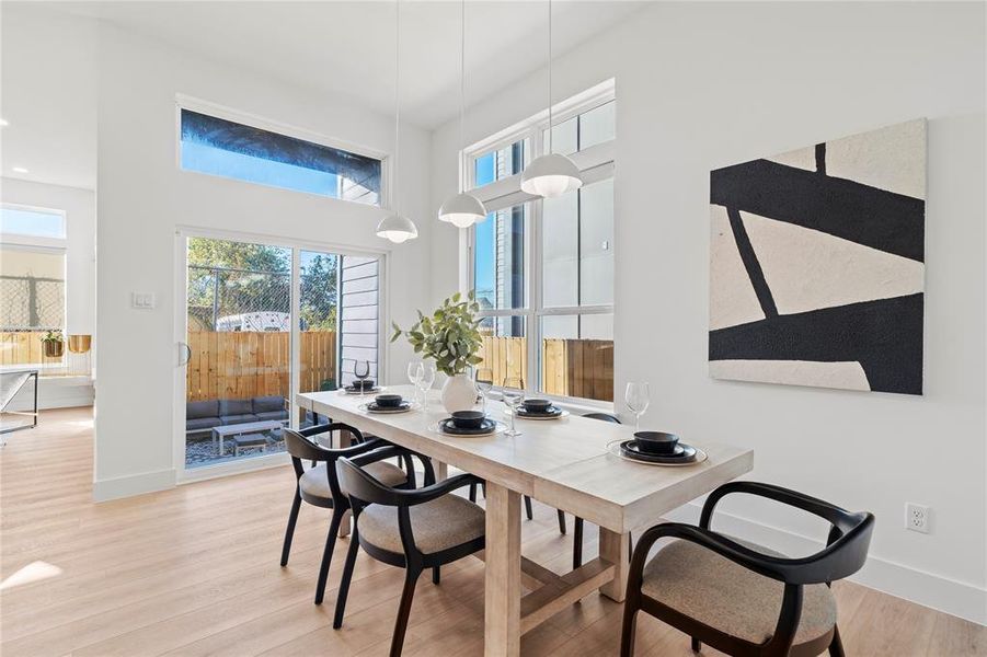 This dining area is bathed in natural light from the large windows and sliding glass doors, creating a warm and welcoming atmosphere. With easy access to the outdoor living space, it's perfect for both indoor and alfresco dining, ideal for hosting gatherings or enjoying a quiet meal at home.