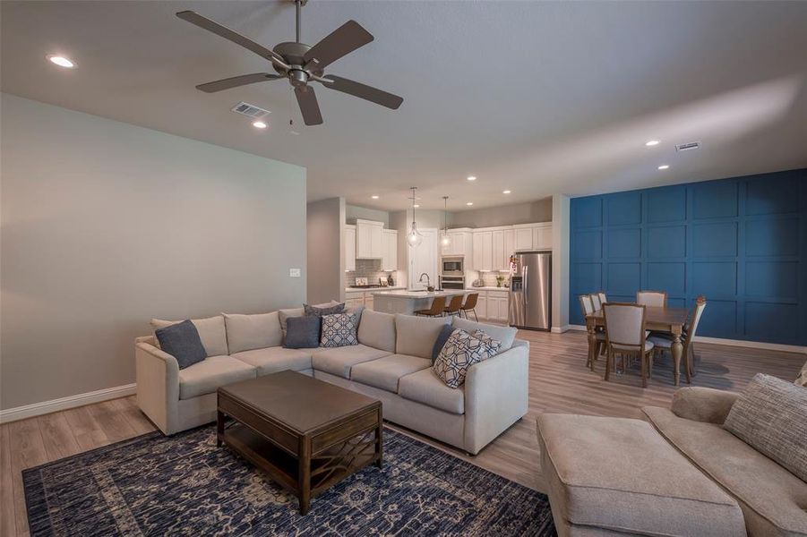 The open concept with the family room, dining room and kitchen join to keep everyone engaged in the activities.