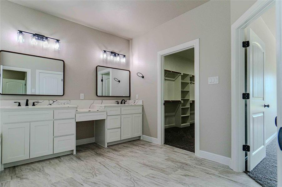 Bathroom with tile patterned floors and dual bowl vanity