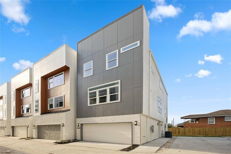 A unique view of the brand new, three-story home with attached two-car garage situated in the highly-desired community of The Heights in Houston.