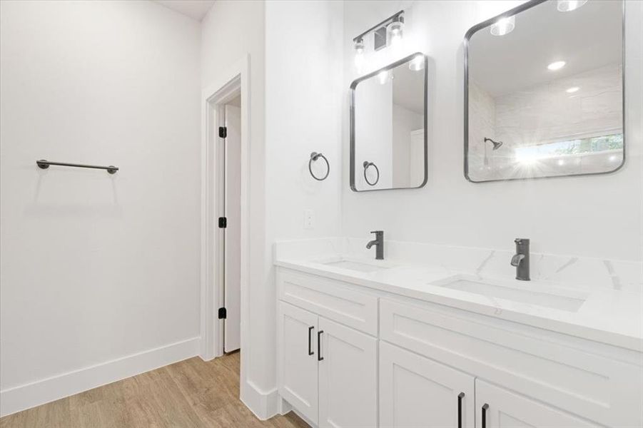 Bathroom featuring vanity and wood-type flooring