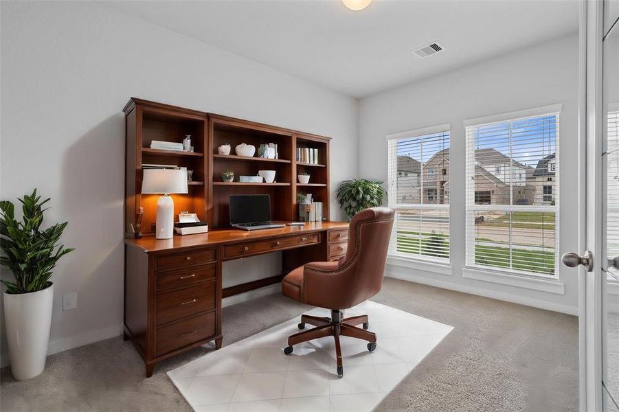 Nestled away quietly in the front of the home is the handsome and grand home office! Featuring high ceilings, custom paint, plush carpet, and large windows with privacy blinds!