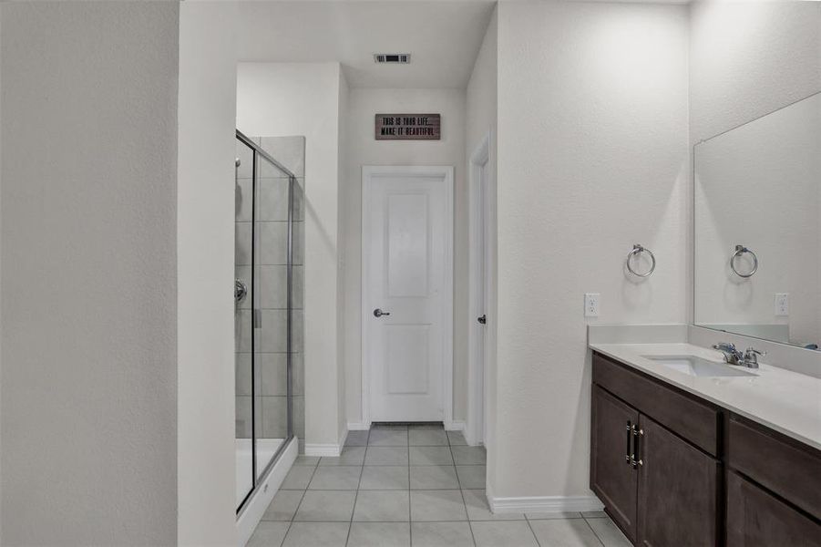 Shower with bench seating, large walk-in closet and private toilet area