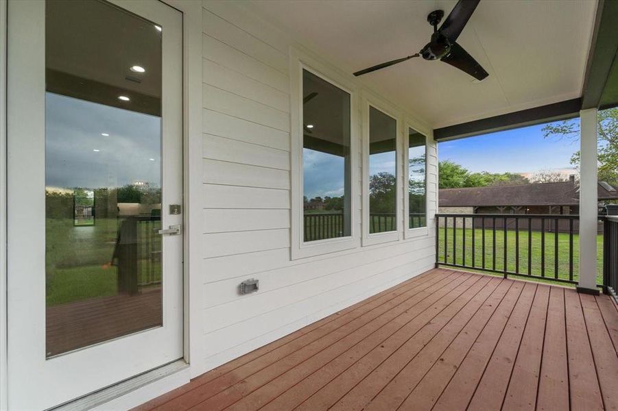 Covered backyard patio, ceiling fan.