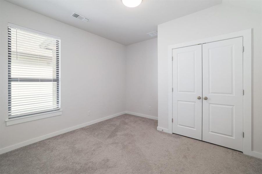 Guest bedroom on main floor with attached full bathroom.