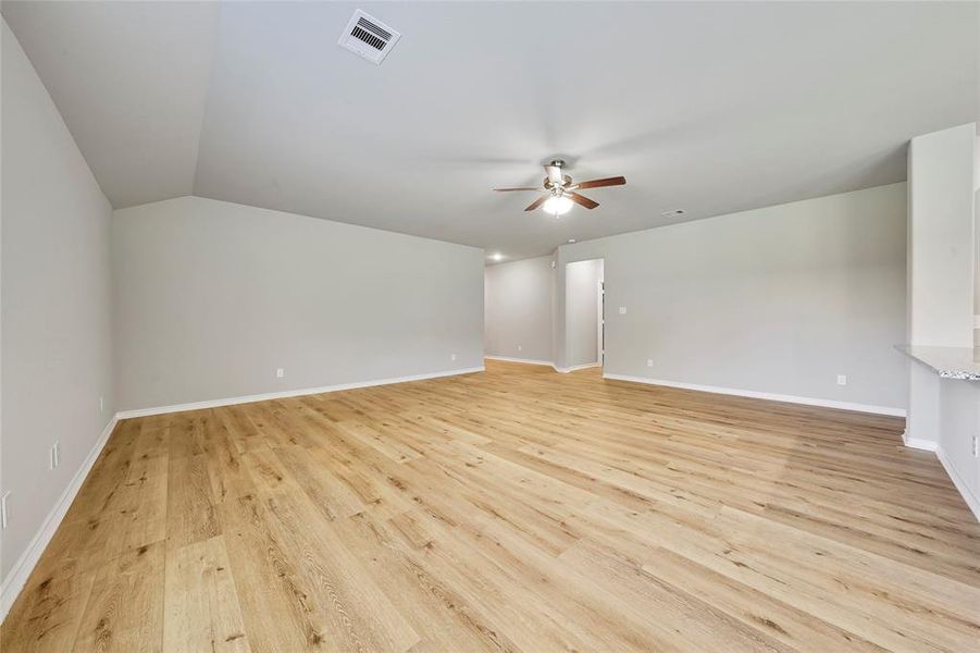 Looking into the massive living room area and into the kitchen