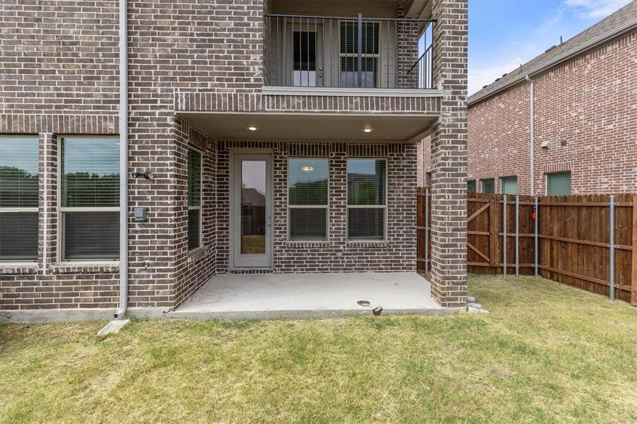 Doorway to property featuring a yard and a patio