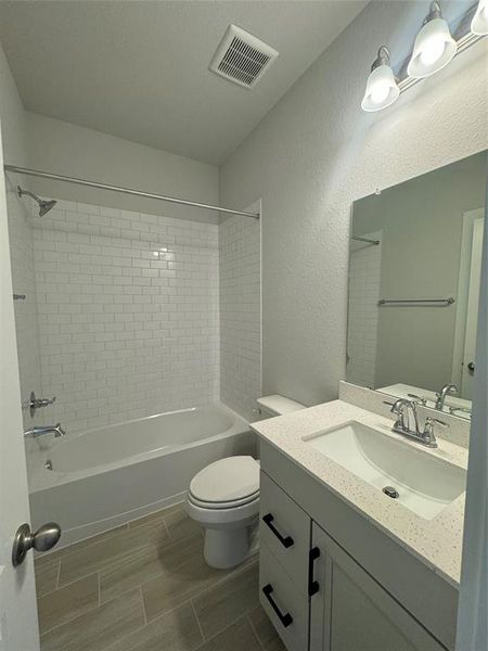 This bright secondary bathroom is just outside of bedroom 2.