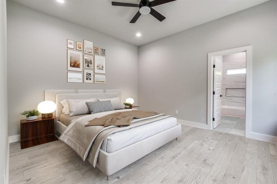 Bedroom with light hardwood / wood-style floors, connected bathroom, and ceiling fan