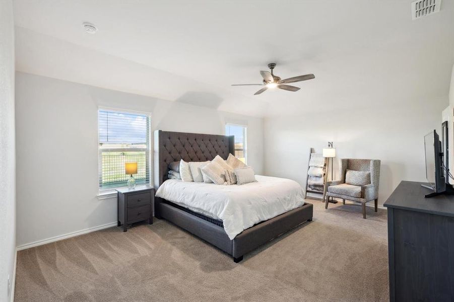 Bedroom with ceiling fan and light colored carpet