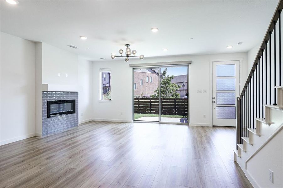 Open living room features plenty of natural light and electronic shades