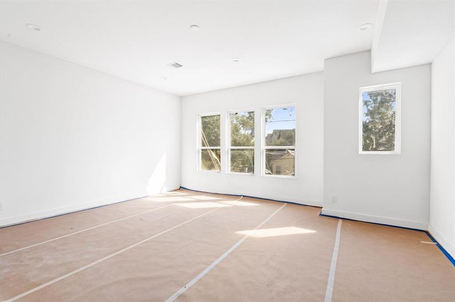 Spacious primary bedroom is truly an owner's retreat.