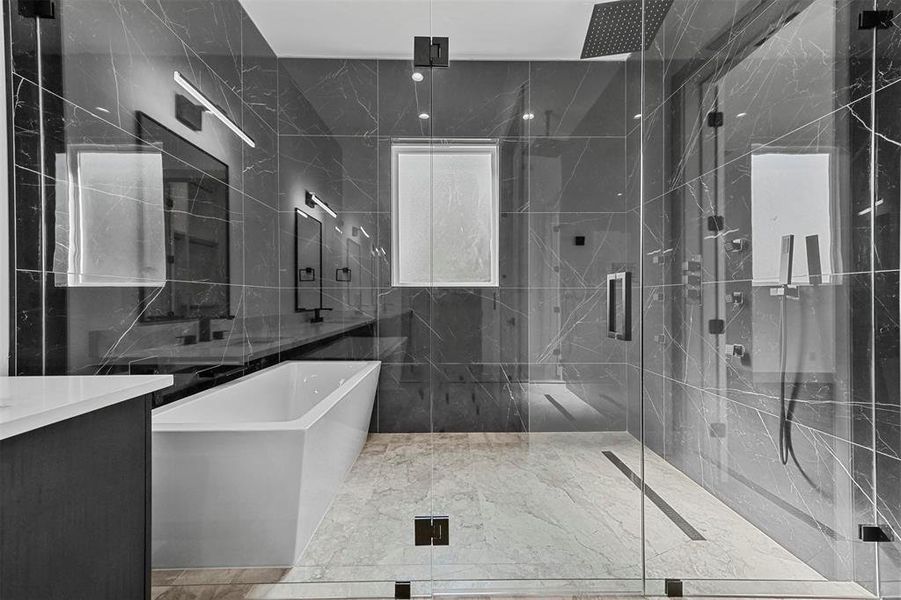 Bathroom featuring tile patterned flooring, tile walls, separate shower and tub, and vanity