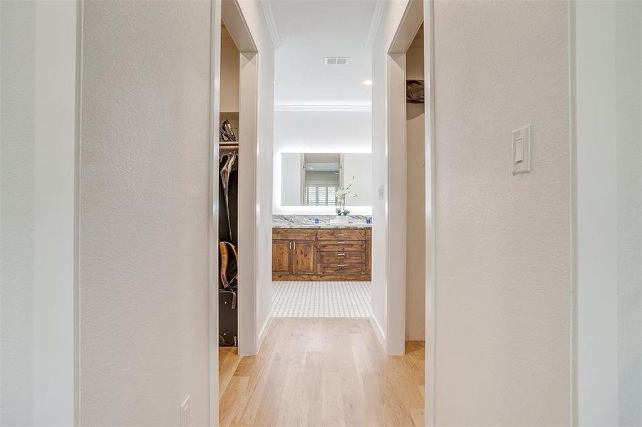 Hallway leading into the master bathroom, with his and her closets.