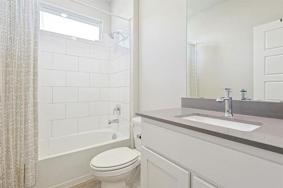 Split Bathroom with undercount sink, crome finishes. quartz countertops and white tile