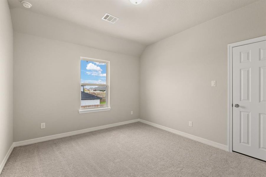 Your secondary bedroom features plush carpet, fresh paint, closet, and a large window that lets in plenty of natural lighting.