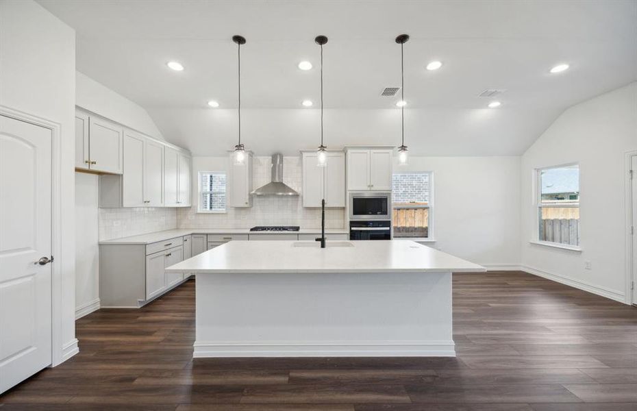 Bright kitchen with oversized island *real home pictured