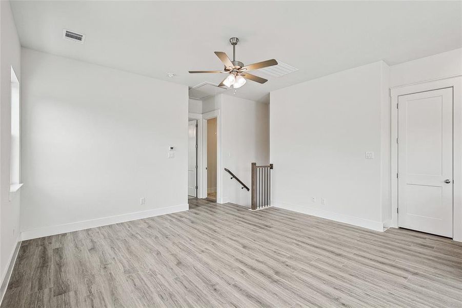 Spare room with ceiling fan and light hardwood / wood-style flooring