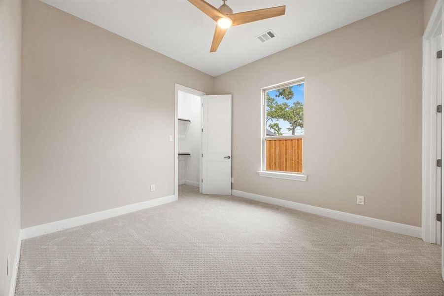 Spare room with light colored carpet and ceiling fan
