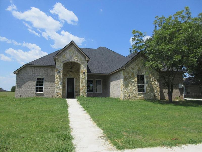 French country style house featuring a front lawn