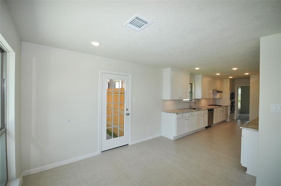 Breakfast Room door to the garage and drive under a Breezeway.